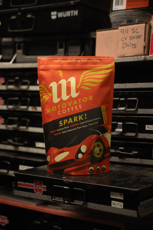 Motovator Spark! coffee on a hardware drawer in a workshop