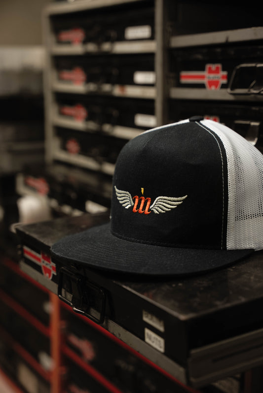 Motovator logo trucker hat on a hardware drawer at an auto shop