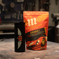 Load image into Gallery viewer, Motowater coffee package and mug on a workshop table
