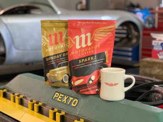 Motovator coffee packages on a vintage tool with a white coffee cup